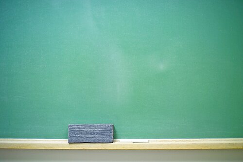 A chalkboard, chalk and a rubber.