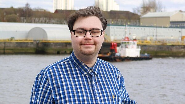 Photo of Ross Stalker in front of the River Clyde