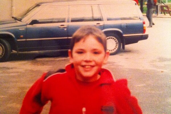 Photo of Adam Harley as a child in a red jacket