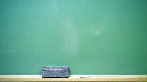 A chalkboard, chalk and a rubber.
