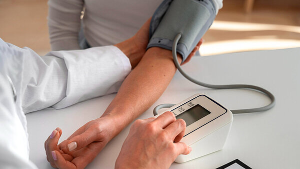 Save our GP Services Person taking blood pressure