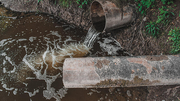 Stop Sewage Dumping Dirty water pouring from pipe into water course
